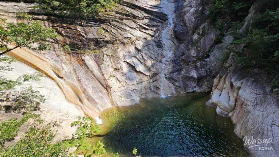 Relaxing on a rock with feet submerged in the ice-cold valley water