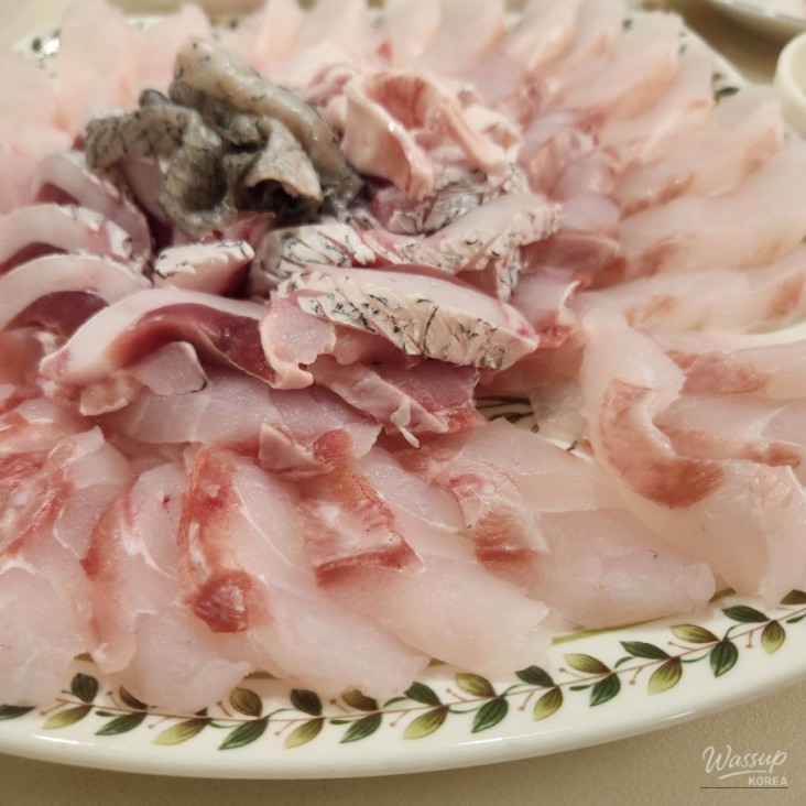 A plate of glistening croaker sashimi