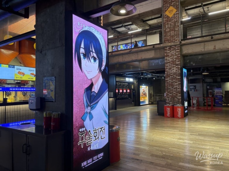 Various anime character figures on display in a glass showcase