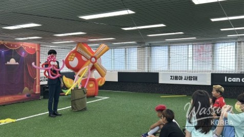 A birthday child participating as a star assistant in a magic show
