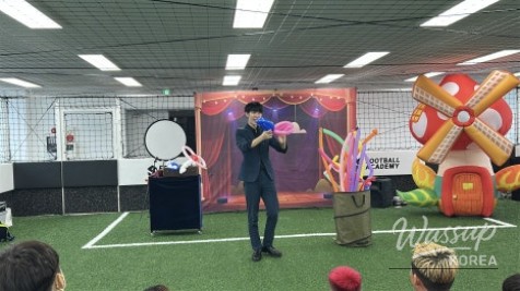 Children laughing and reacting with wonder during a live magic performance