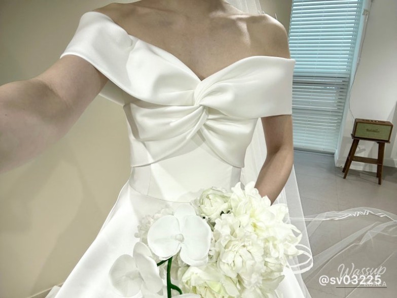 The elegant train of a wedding dress during a fitting session