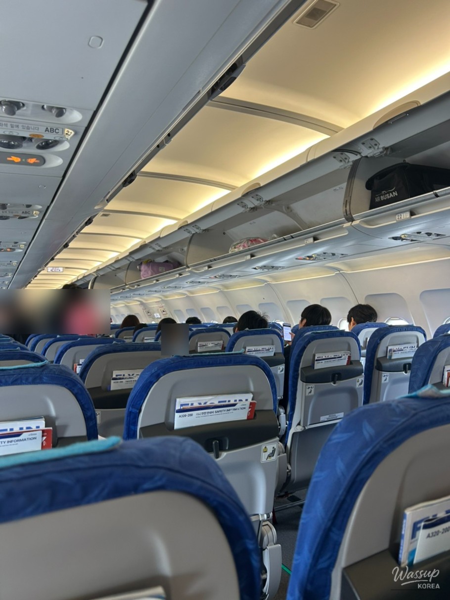 Narrow aisle and compact seating inside Air Busan BX171