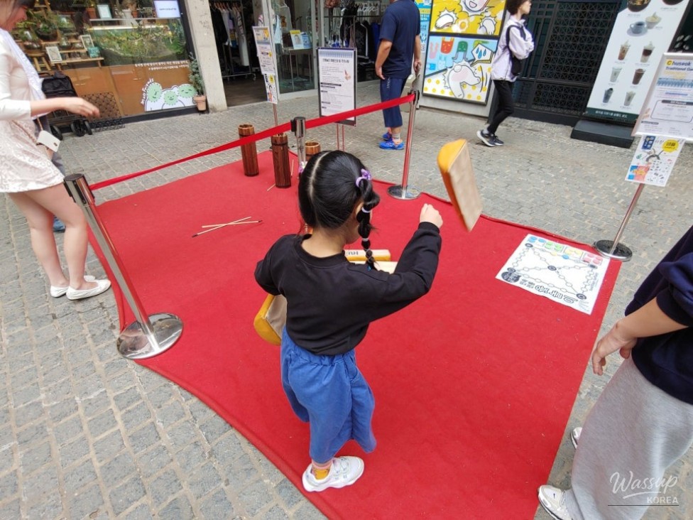 Detailed close-up of traditional Korean wooden crafts in a shop window