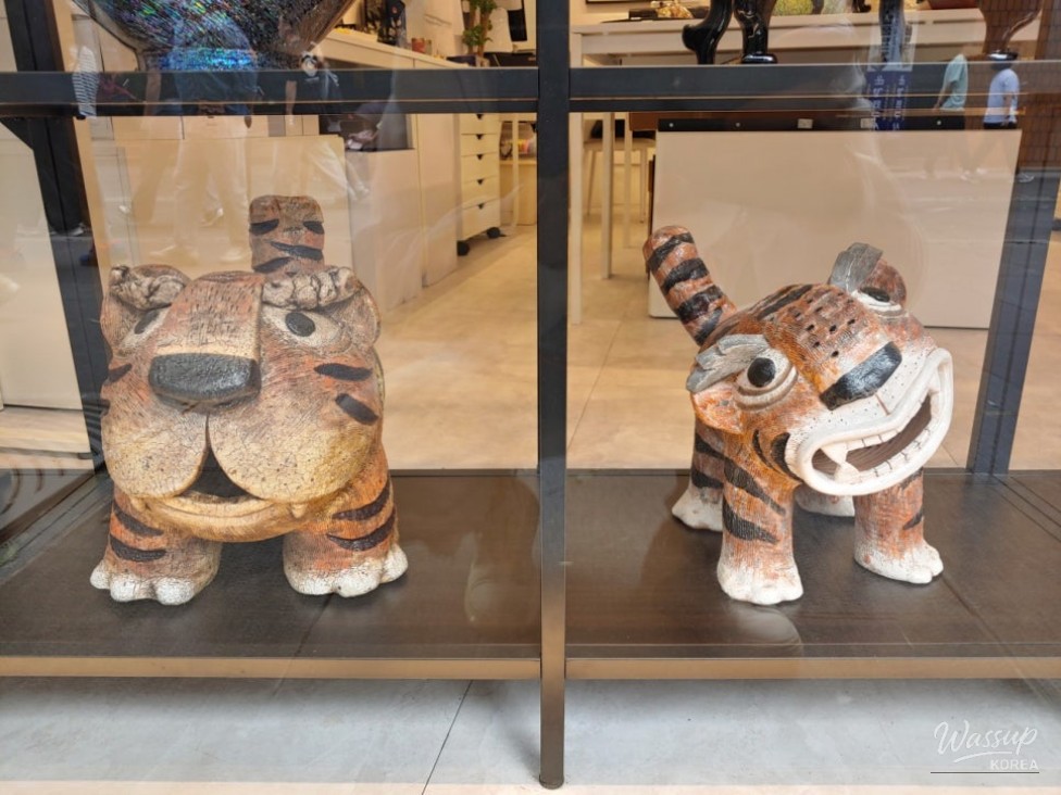 Intricate ceramic dolls and traditional Korean craft items on display