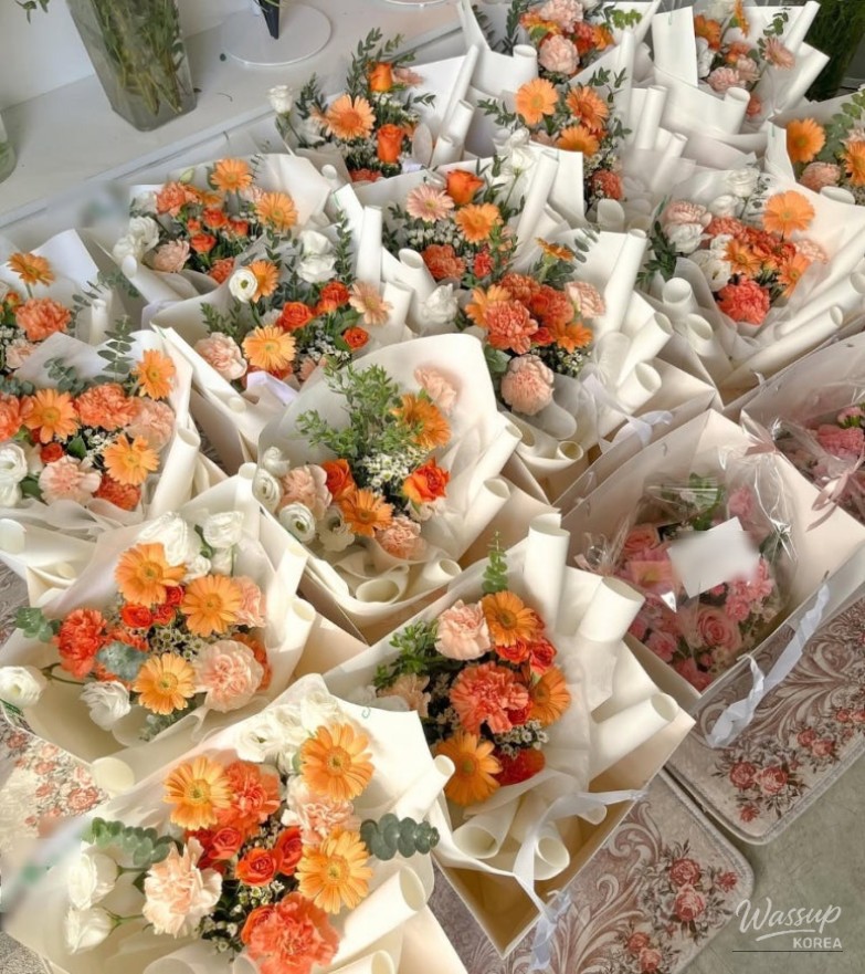 A sophisticated corporate event bouquet featuring warm coral and autumn tones