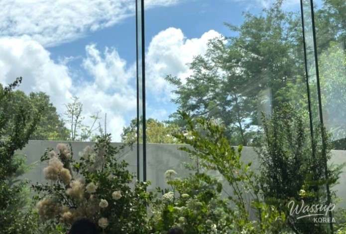 A fairytale-like wedding ceremony scene at Maison D'Italie with hanging flower decorations