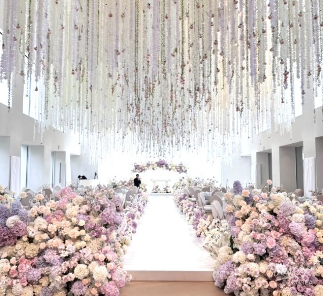 Touching scene of the bride and groom sharing their vows in the intimate hall