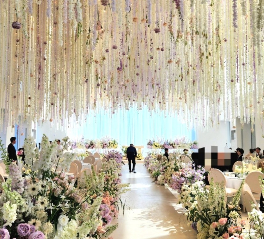Dreamlike moment of the couple's march under the beautiful floral ceiling
