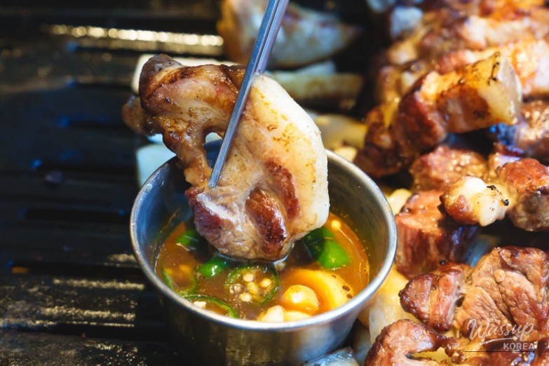 Tender chewy noodles being lifted from the cold broth