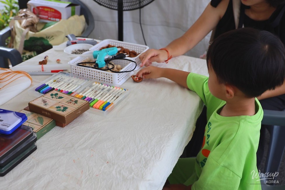 Lively food booth area with visitors enjoying various local delicacies