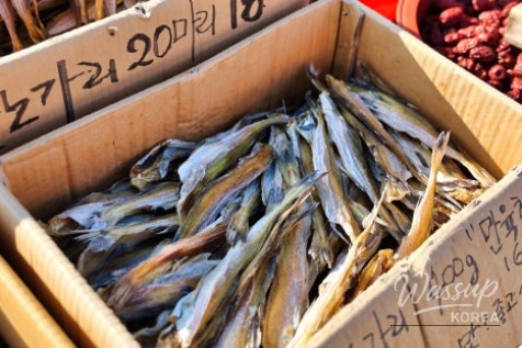 A variety of traditional Korean side dishes displayed in large basins