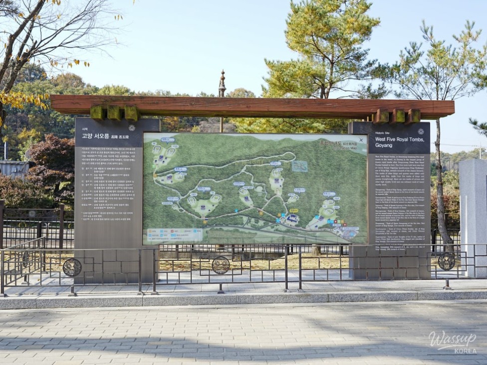 Stone statues guarding the royal tombs amidst autumn leaves