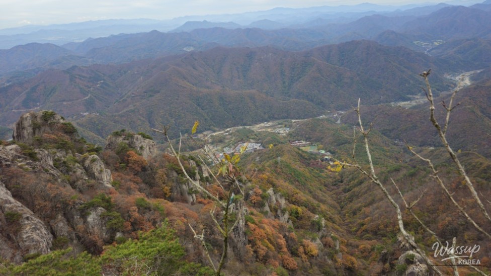 The metallic suspension bridge structure blending with the rocky landscape