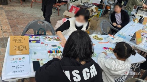 Families gathered around the food zone enjoying free fishcake soup and pancakes