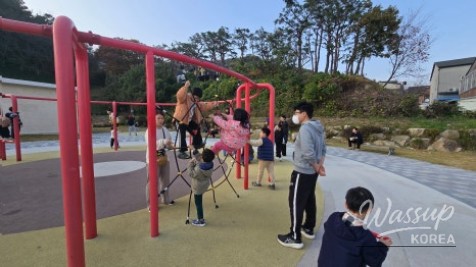 A vocalist performing live on the main stage under the autumn sky