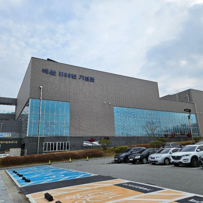 The modern and grand facade of the Yesan 1100 Memorial Hall on Cherry Blossom Road