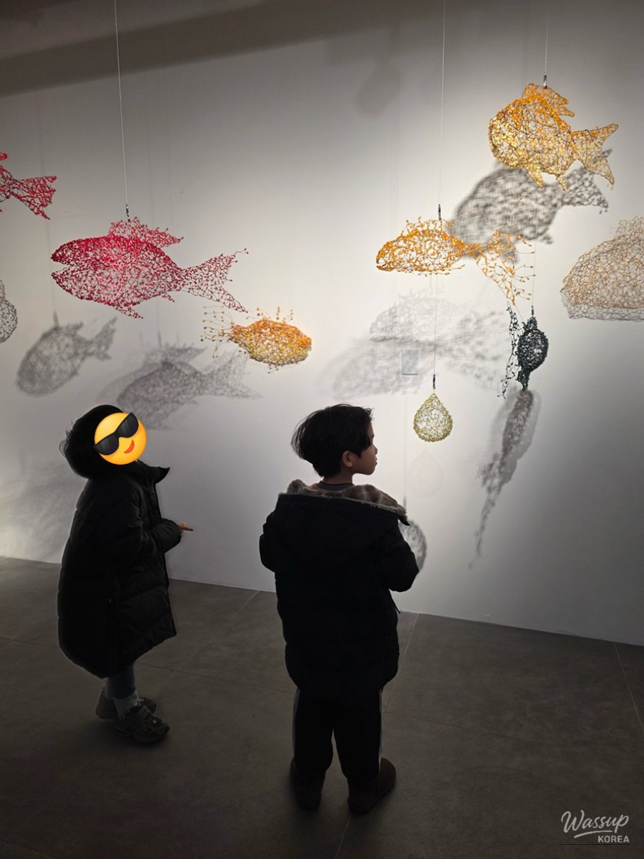 Children carefully working on a woodworking project in the Craft Village