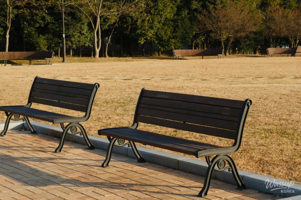 Park scenery surrounding Sujeong-ri heritage sites with benches and open space