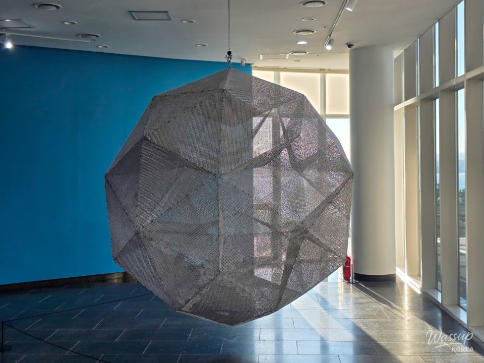 Open sea view framed by traditional buildings