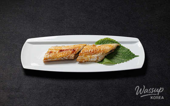 Grilled eel served with rice and side dishes in Jeju