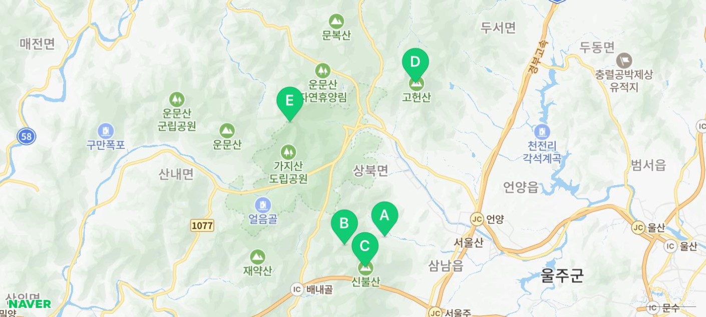 Hikers resting near a Yeongnam Alps summit marker