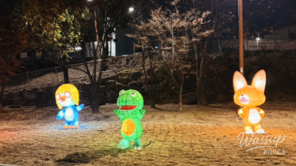 Couples walking through illuminated festival zone