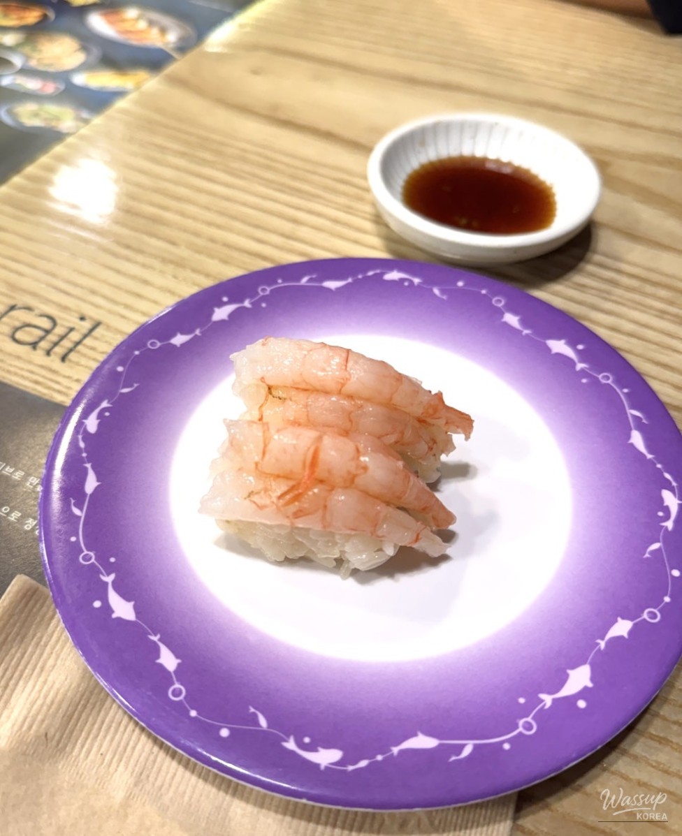 Assorted sushi plates and conveyor belt setup at Kuukuu Blue Rail Kondae