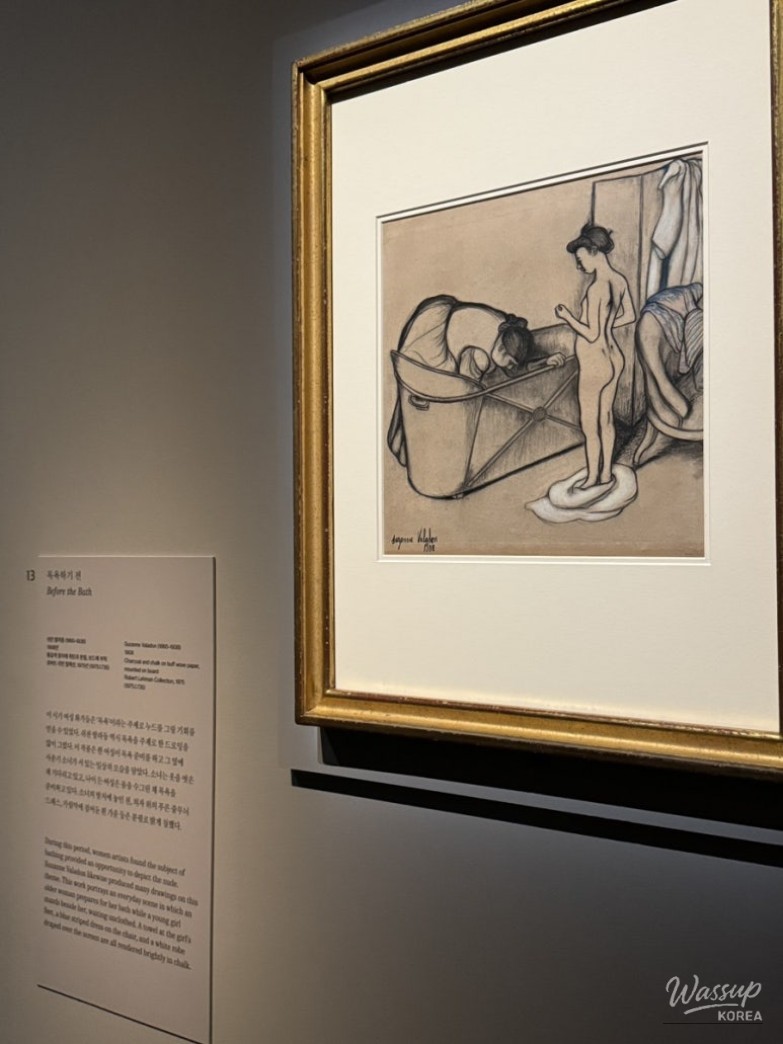 Spacious gallery hall with landscape oil paintings under soft museum lighting