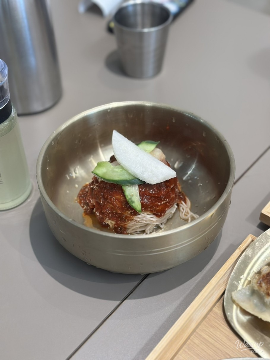 Pyongyang cold noodle dining moment captured mid-meal at home