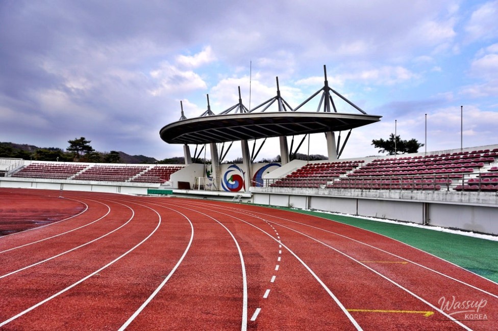 Athletic track and natural grass field inside Goesan Comprehensive Sports Complex