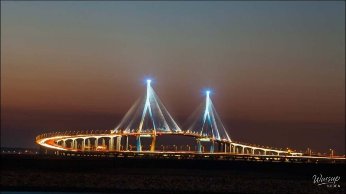 Night view of illuminated Incheon Bridge resembling a galaxy over the sea