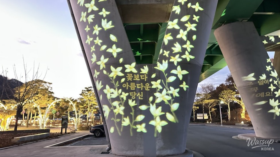 Wide riverside walking path illuminated by gentle lights at Goeun Light Park