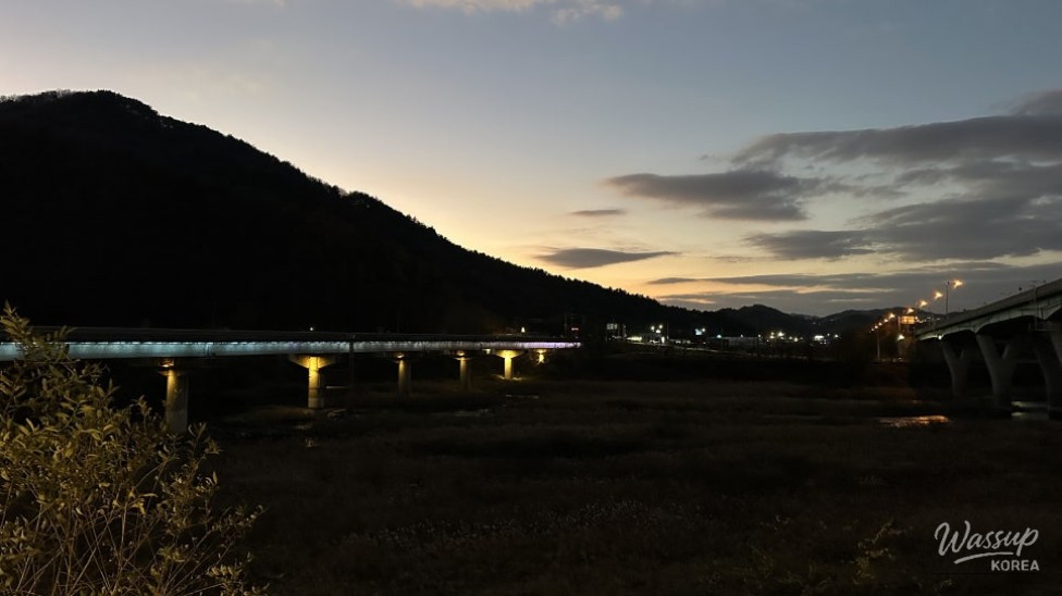 Quiet riverside lights creating a calm night atmosphere in Goesan