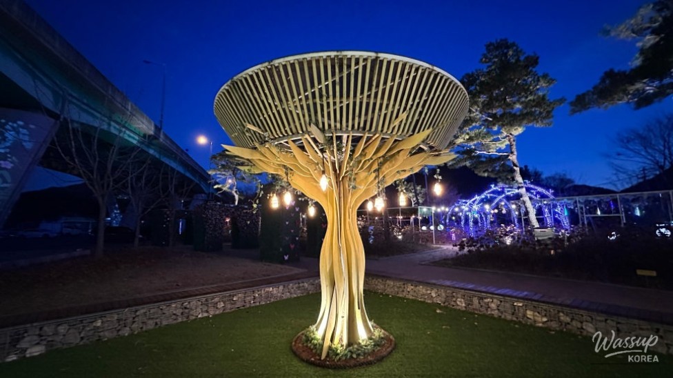Illuminated bridge pillars forming artistic light patterns at Goeun Light Park