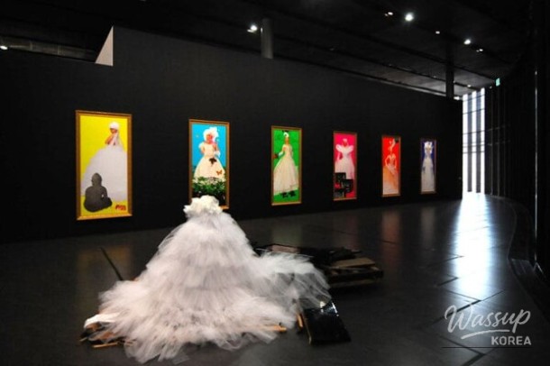 A vibrant exhibition hall filled with colorful video art and laser installations