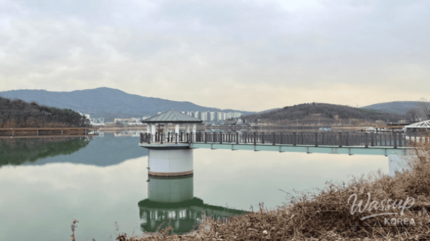 Illuminated bridge and walkway over Baegun Lake at night