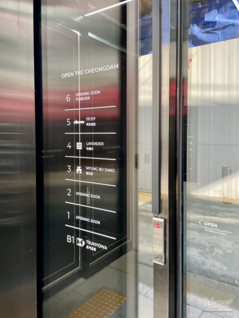 Interior view of Myungbodang showing the elegant D-shaped bar seating and open kitchen