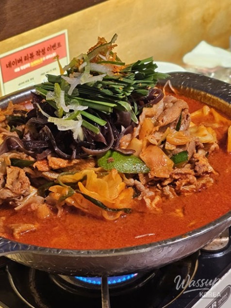 Snow falling over a busy street at night