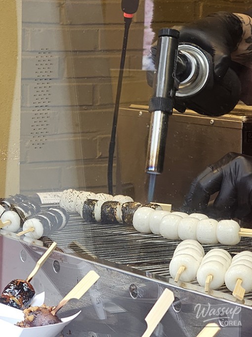 A bowl of clear shio ramen with traditional toppings served in a cozy Kondae eatery