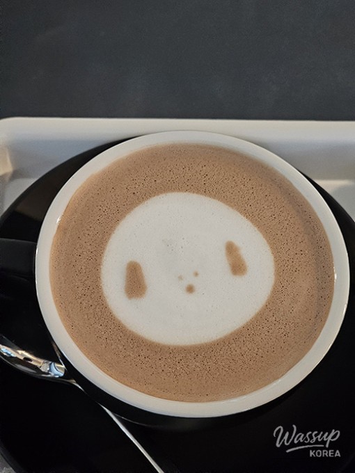 Close-up of a matcha pudding dessert with a dollop of cream