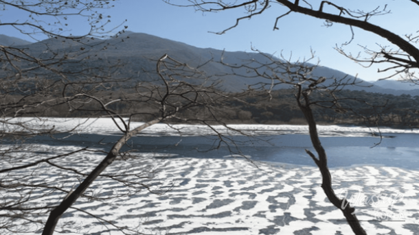 The peaceful walking path of Sanmaki Old Road covered in light snow