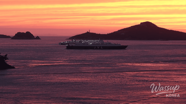 Aerial perspective of Jindo's coastal roads and islands during the golden hour