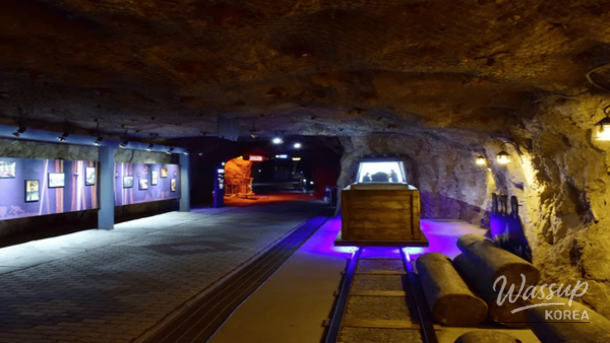 Illuminated stalactites and geological formations inside the mystical Hwaam Cave
