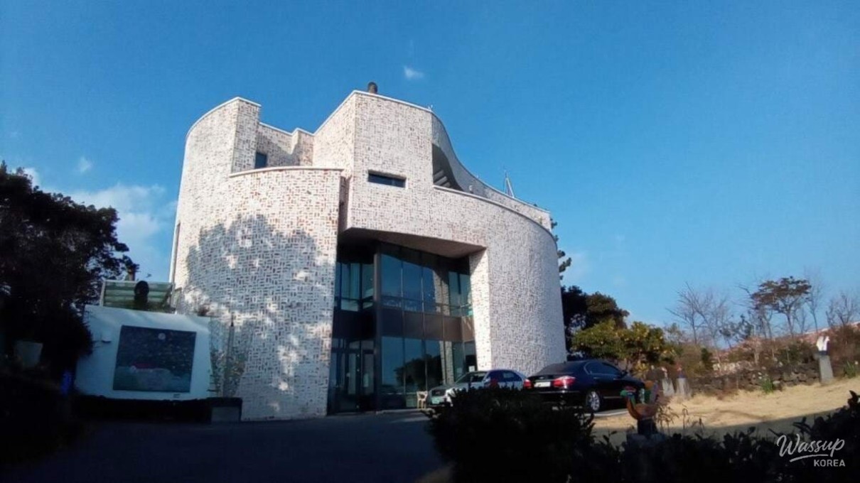 Vibrant and colorful paintings by Lee Waljong displayed inside the bright exhibition hall