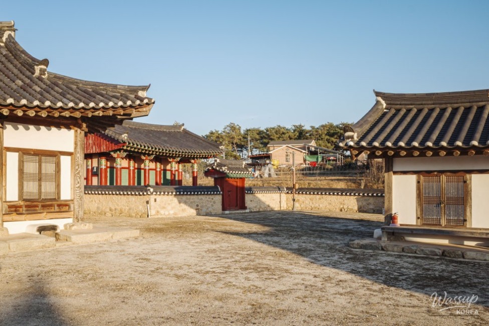 The intricate traditional roof tiles and wooden beams of Yisan Seowon against a clear sky
