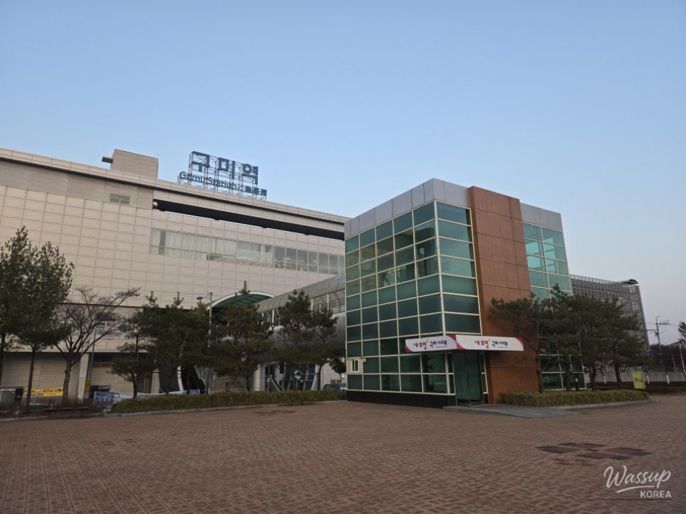 A wide view of the modern Gumi Station Rear Plaza with brick paving and a spacious layout