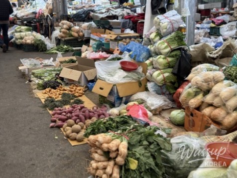Vibrant market scene with vendors selling fresh agricultural products at Waegwan Market