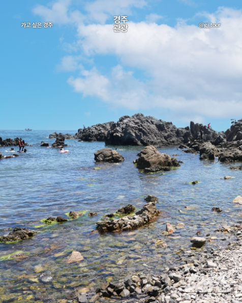 A wide shot of crowds gathered at the beach to watch the first sunrise