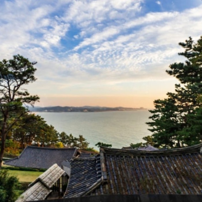 The roofed wooden corridor of Sanghwar Garden stretching along the scenic Boryeong coastline